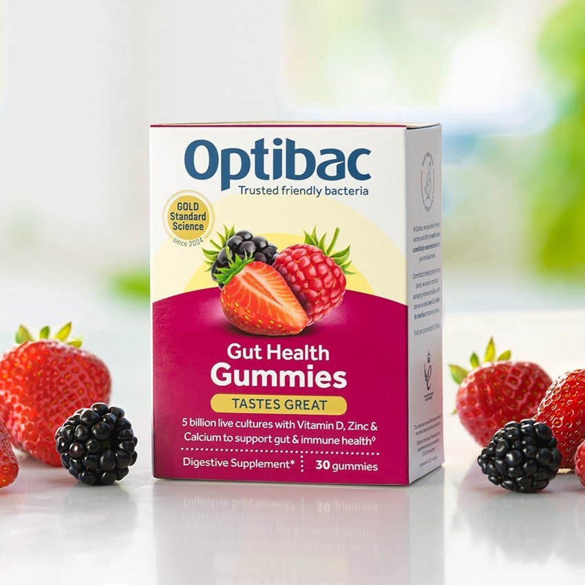 Box of Optibac Gut Health Gummies with mixed berries around it, promoting digestive support and immune health with live cultures and vitamins.