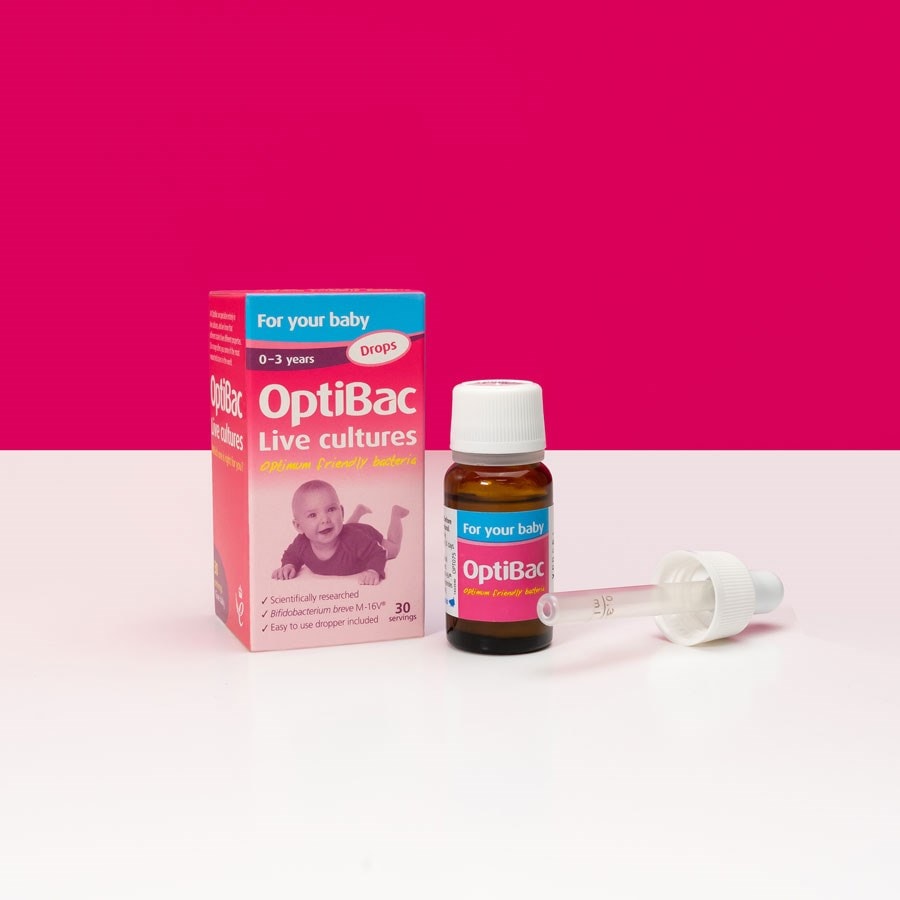 OptiBac Live Cultures drops for babies, with box and dropper, on a pink and white background. Suitable for ages 0-3 years.