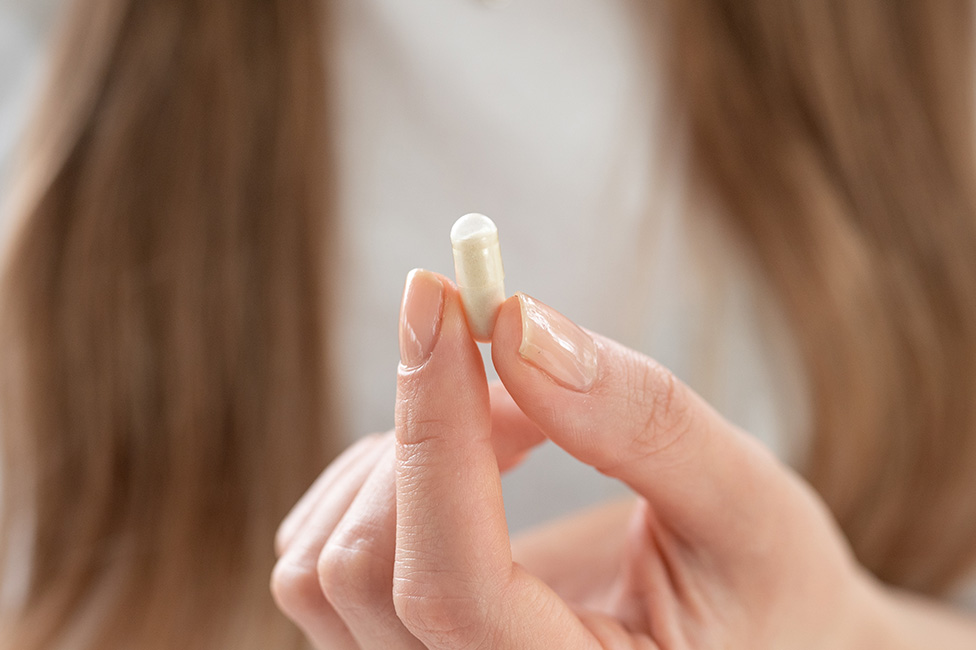 capsule held by someone