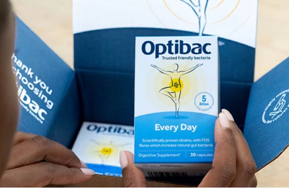 Person holding a box of Optibac Every Day probiotics with packaging.