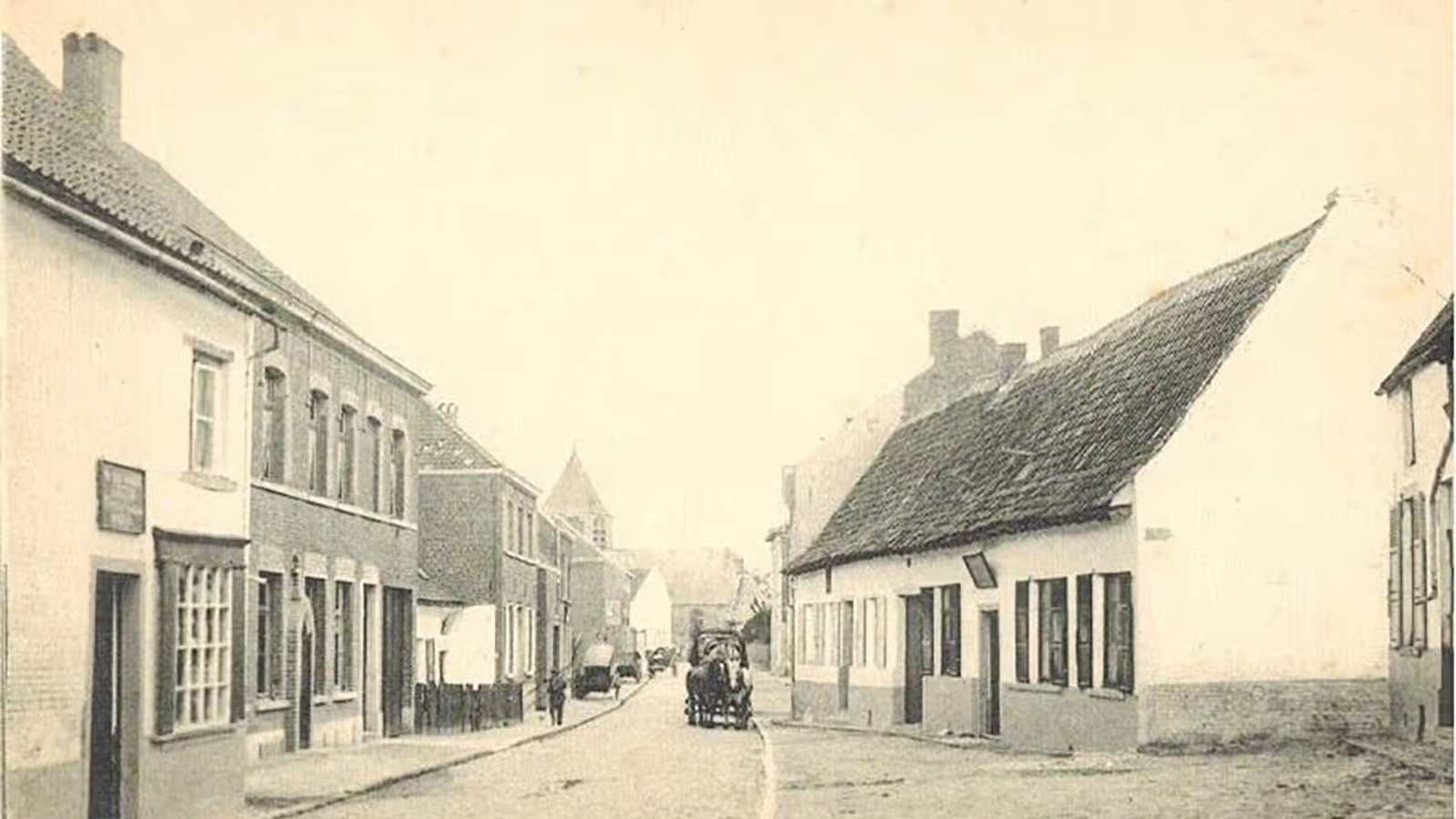 Vintage street scene with cobblestone road, lined with old buildings. A horse-drawn carriage is in the distance.