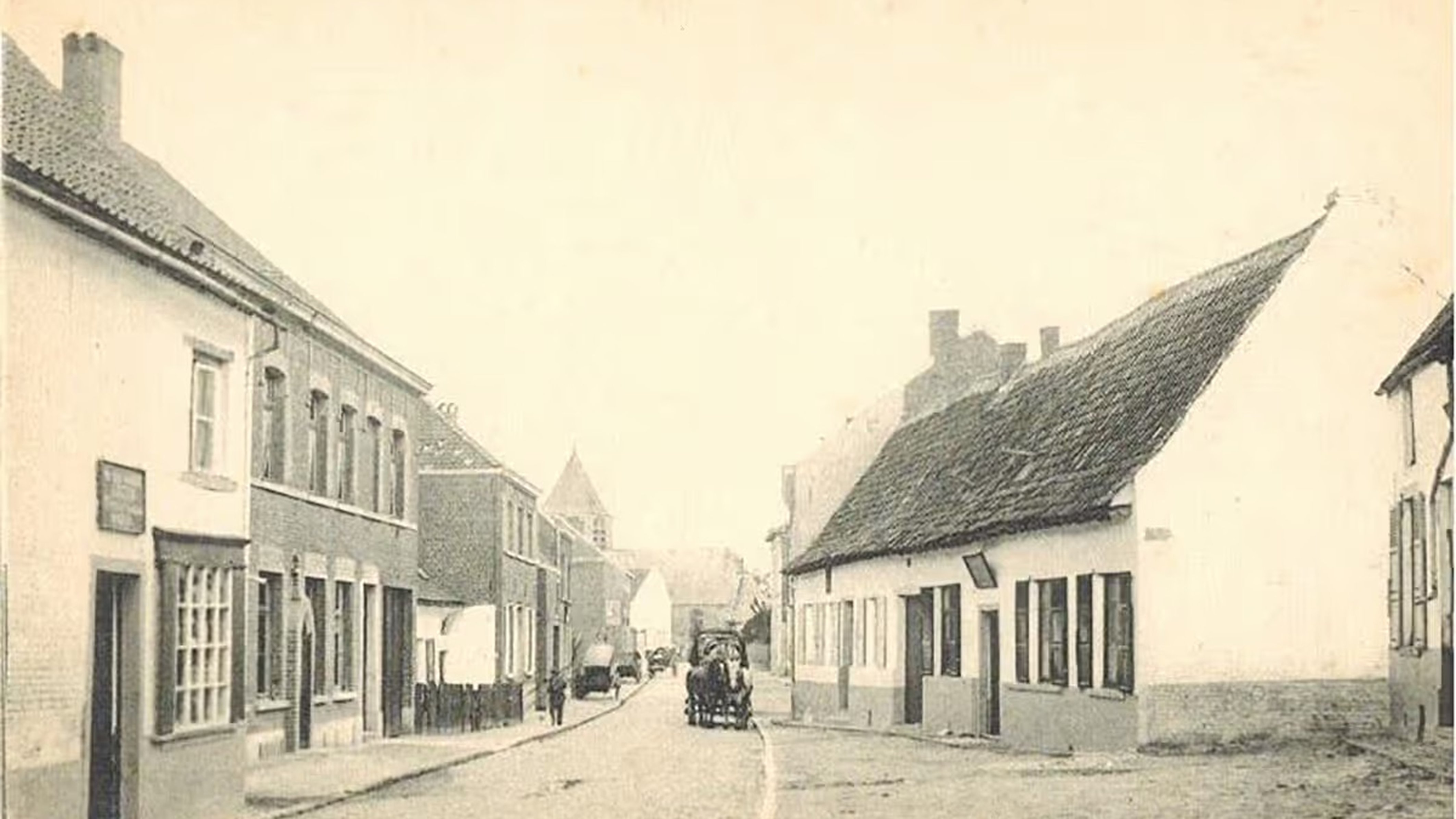 Vintage street scene with cobblestone road, lined with old buildings. A horse-drawn carriage is in the distance.