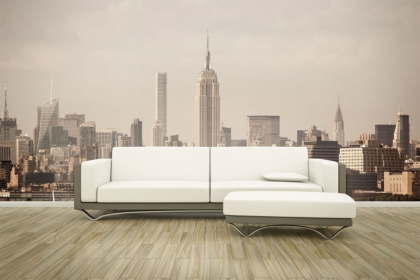 Modern white sectional sofa on light wood floor, set against a wall mural of New York City skyline with the Empire State Building centered.