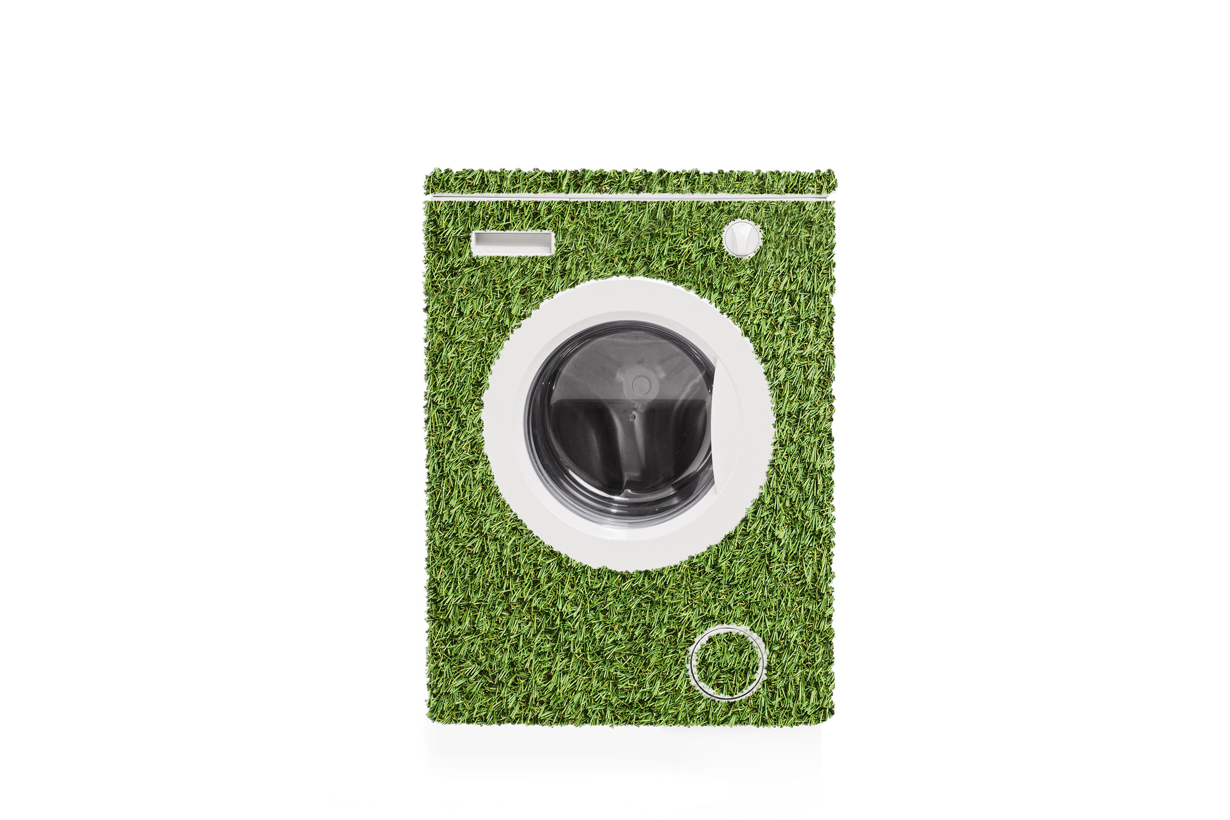 Front-loading washing machine covered in green grass-like texture, symbolizing eco-friendliness or sustainability.