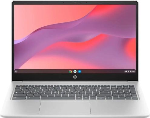 A silver laptop with a grey keyboard and a screen displaying a pink and purple abstract background. It features the Chrome OS interface.