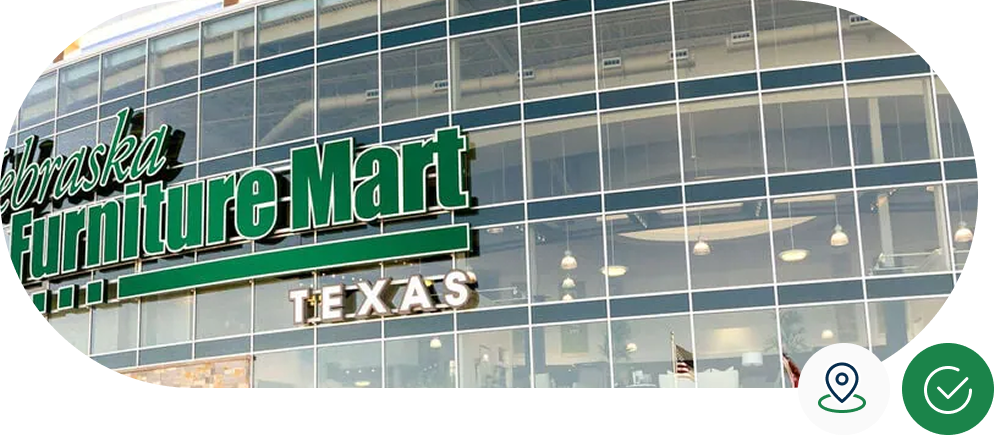 Exterior of Nebraska Furniture Mart Texas store, featuring large glass windows and prominent green signage.