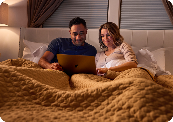 A couple browsing a laptop together
