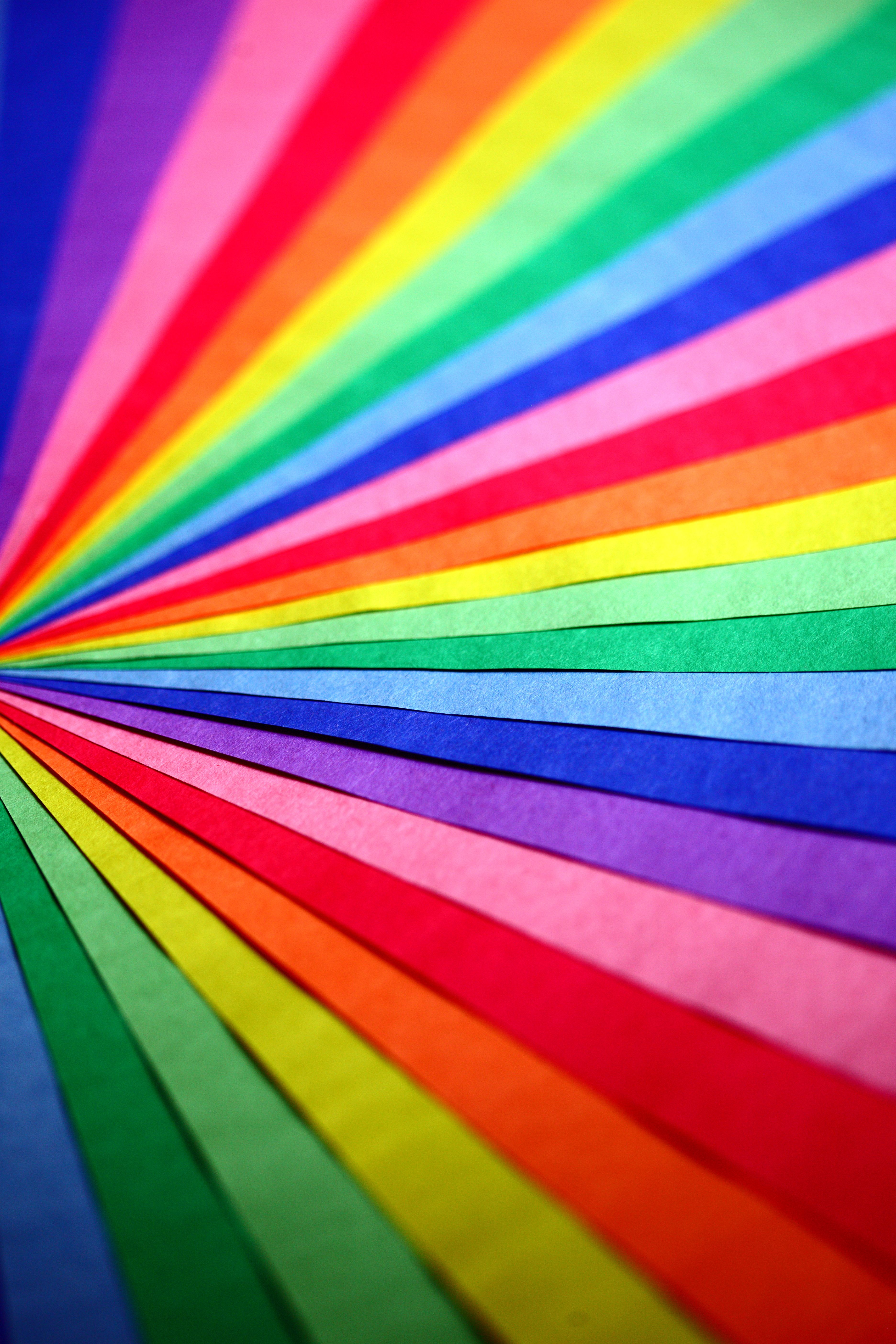 Colourful paper lined up in a rainbow.