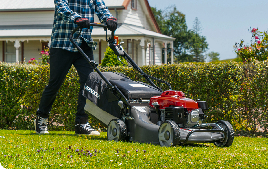 man pushing mower