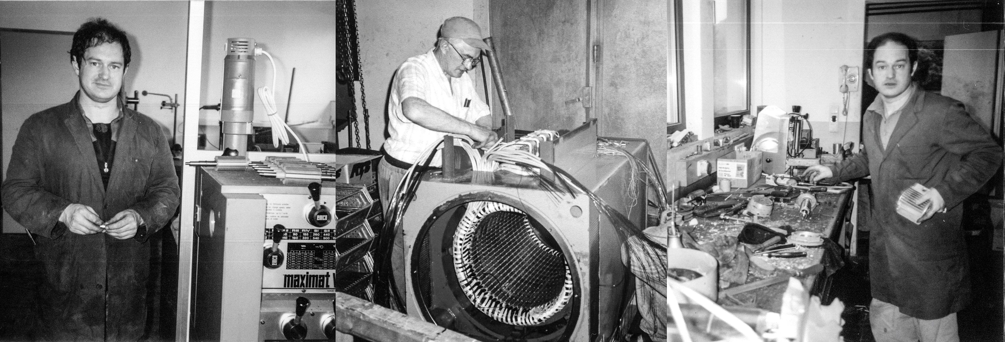 Drei Männer arbeiten in einer Werkstatt mit Maschinen und Werkzeugen; einer bedient eine Maschine, während die anderen mit Werkzeugen daneben stehen. Schwarz-Weiß-Foto.