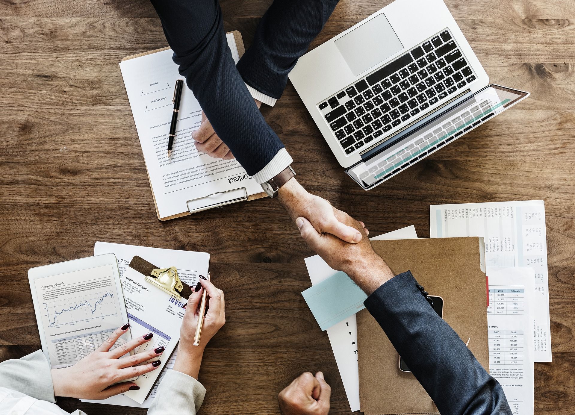 business handshake over work