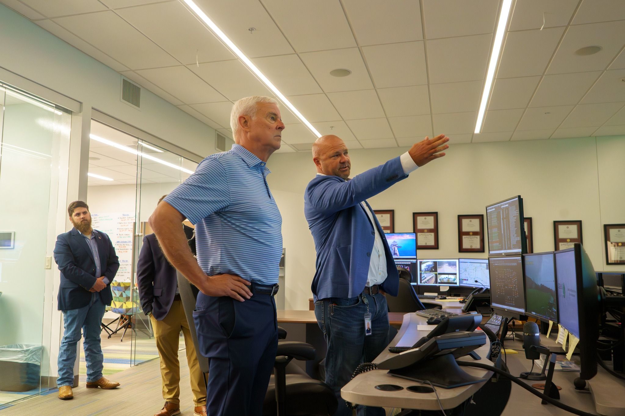 Rep. Steve Womack, center, looks on as Corey Funk, Ozarks' supervisor of system operations, shows Ozarks' control room.