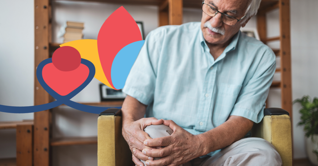 Elderly man sitting in a chair, holding his knee in pain, with a colorful abstract shape in the background.
