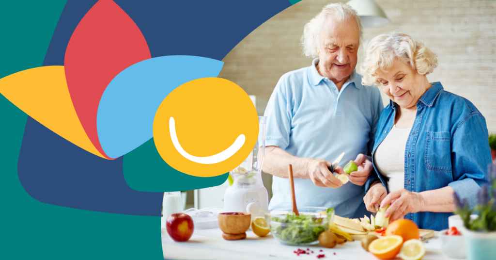 Elderly couple preparing food together in a bright kitchen, surrounded by fresh fruits and vegetables, with colorful abstract shapes in the background.