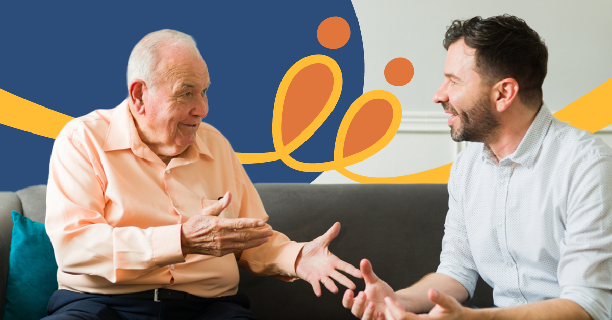 Two men engaged in a lively conversation on a couch, with a colorful abstract background featuring blue, orange, and yellow elements.