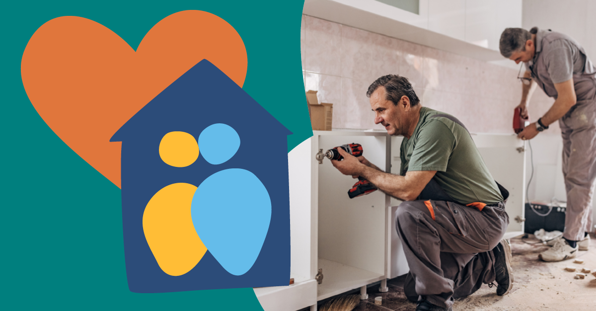 Two men installing kitchen cabinets, one using a drill. A graphic of a heart and house symbol is on the left.