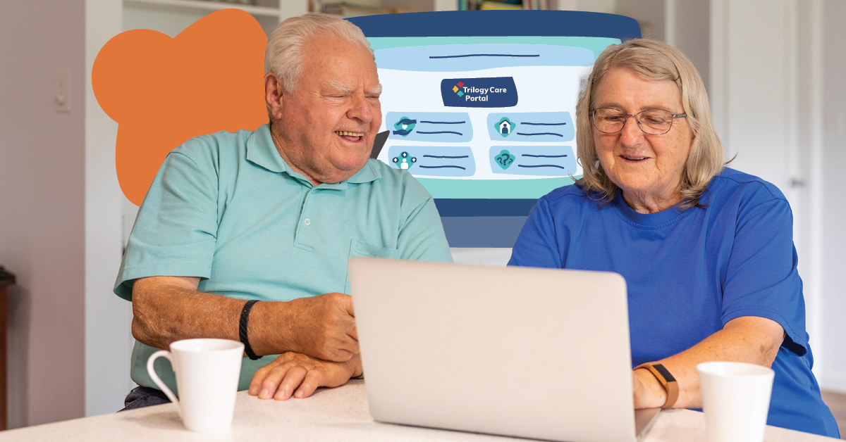Elderly couple using a laptop together at a table with mugs, a colorful screen in the background displaying "Aubrey Care Portal."
