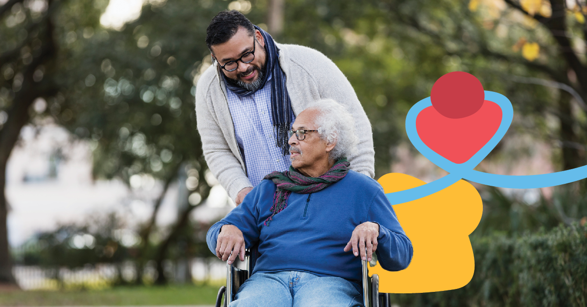 A smiling man stands behind an elderly person in a wheelchair outdoors, surrounded by trees and colorful abstract shapes.