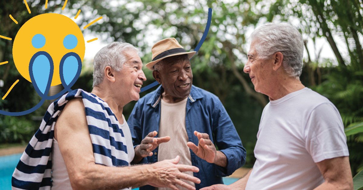 Three elderly men talking by a poolside, one with a striped towel over his shoulder. They appear relaxed and engaged in conversation.