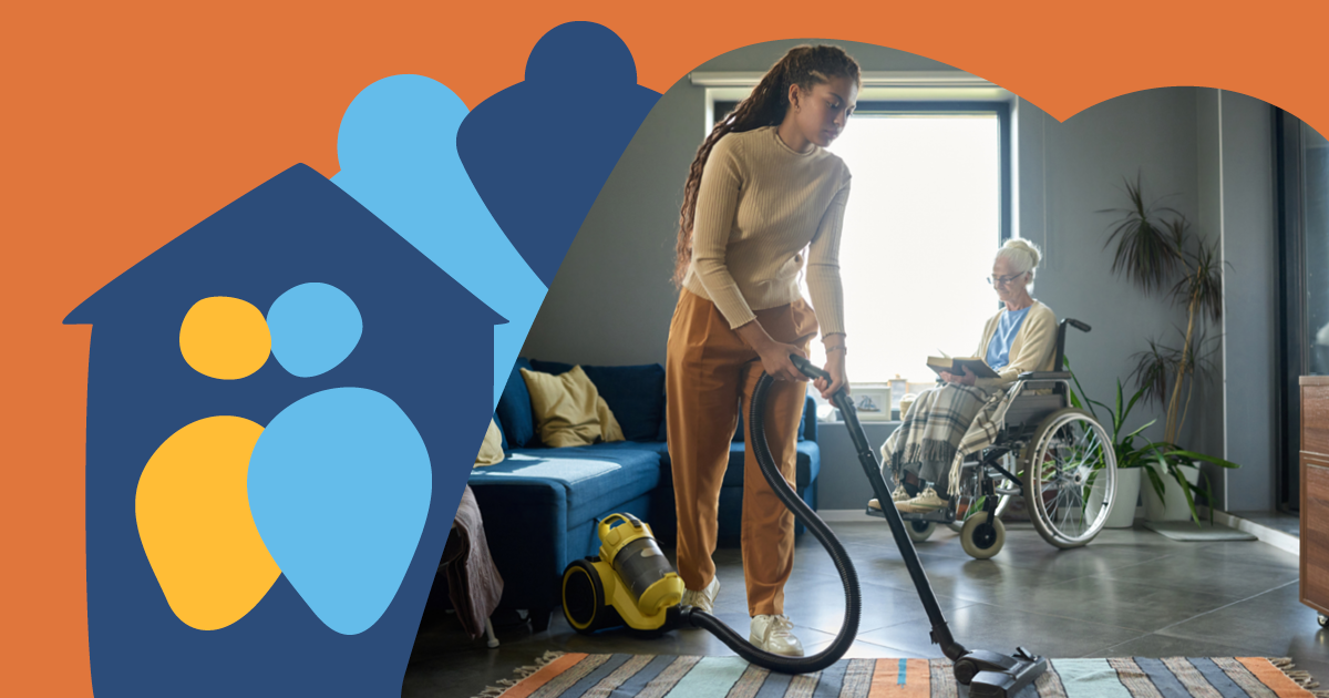 Person vacuuming a living room with an elderly person in a wheelchair nearby. Graphic of a house and family icons overlays the image.