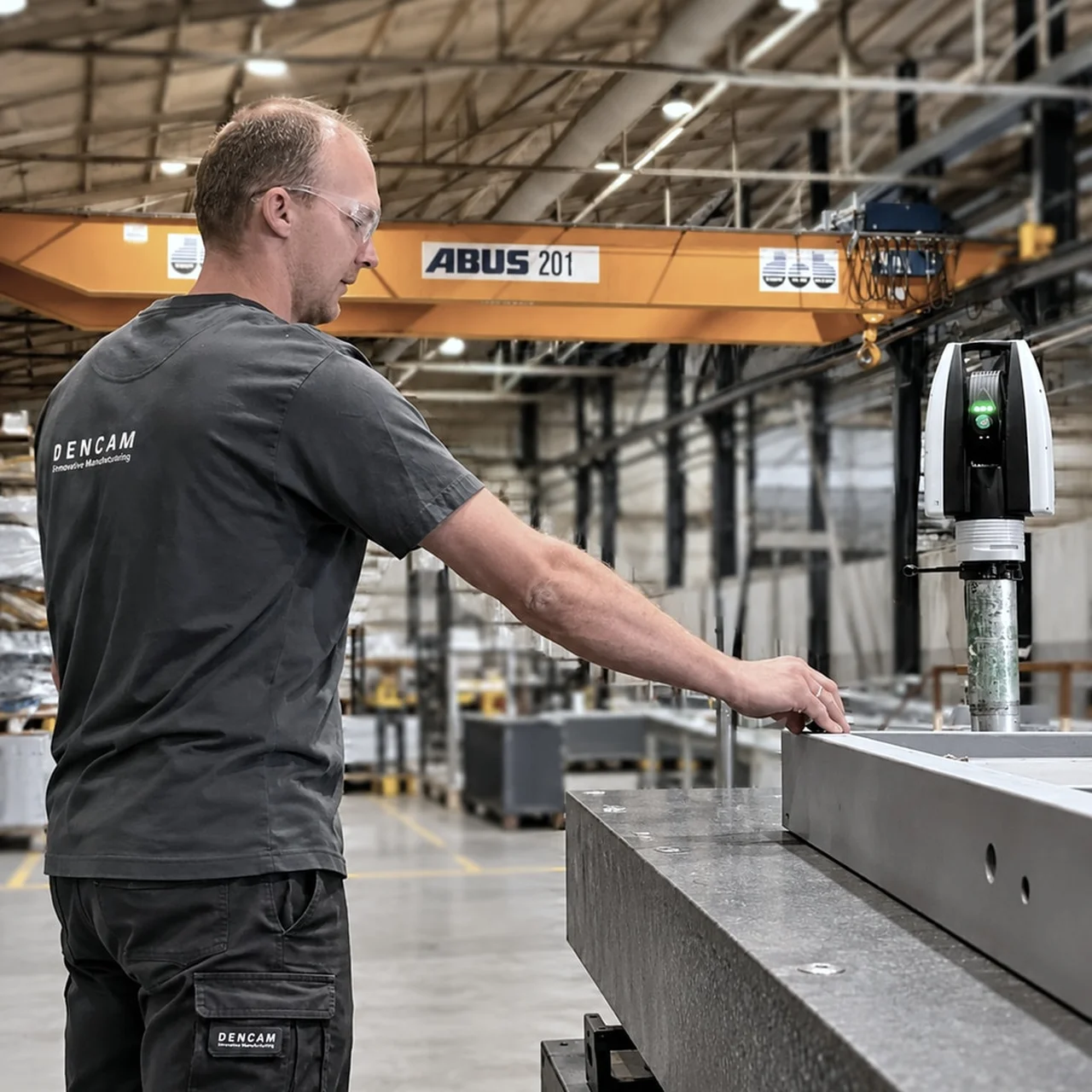 Technician taking laser tracker measurements of composite tooling