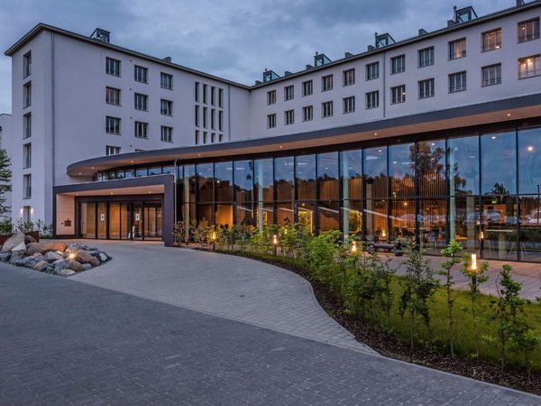 Mariandl am Meer® Ferienwohnungskomplex vor dramatischem Himmel.