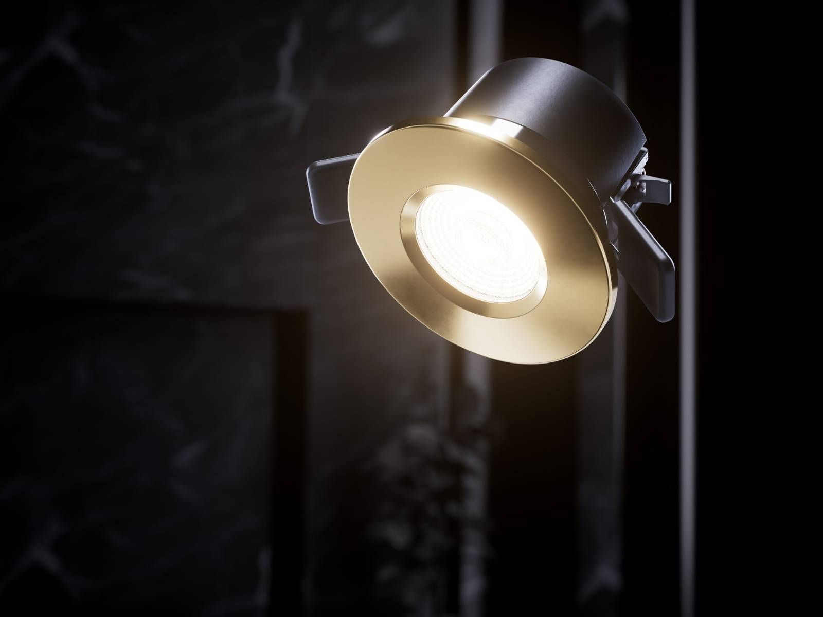 Nahaufnahme eines runden, goldglänzenden LED-Einbaustrahlers (Downlight) mit eingeschaltetem, warmweißem Licht.