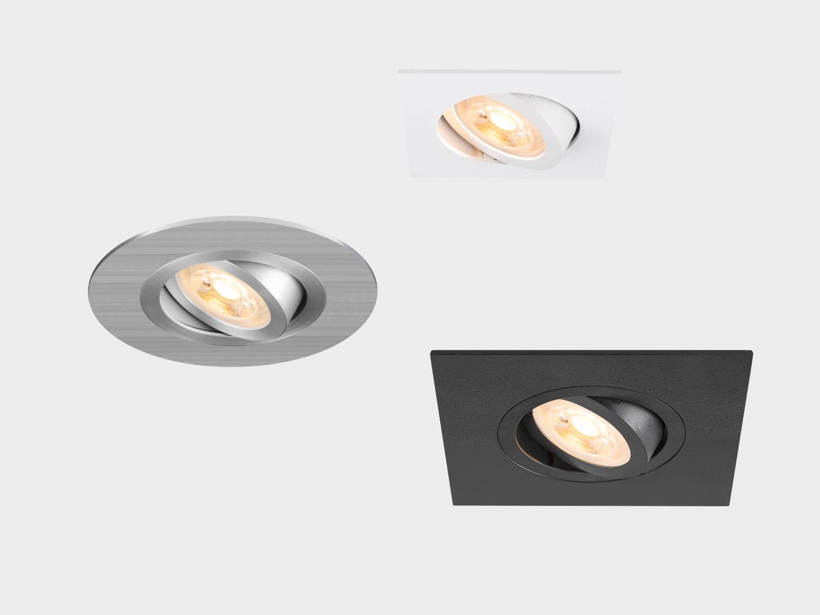 Drei NEW TRIA® Deckeneinbauleuchten: eine runde silberne, eine quadratische weiße und eine quadratische schwarze, jeweils mit leuchtender LED.