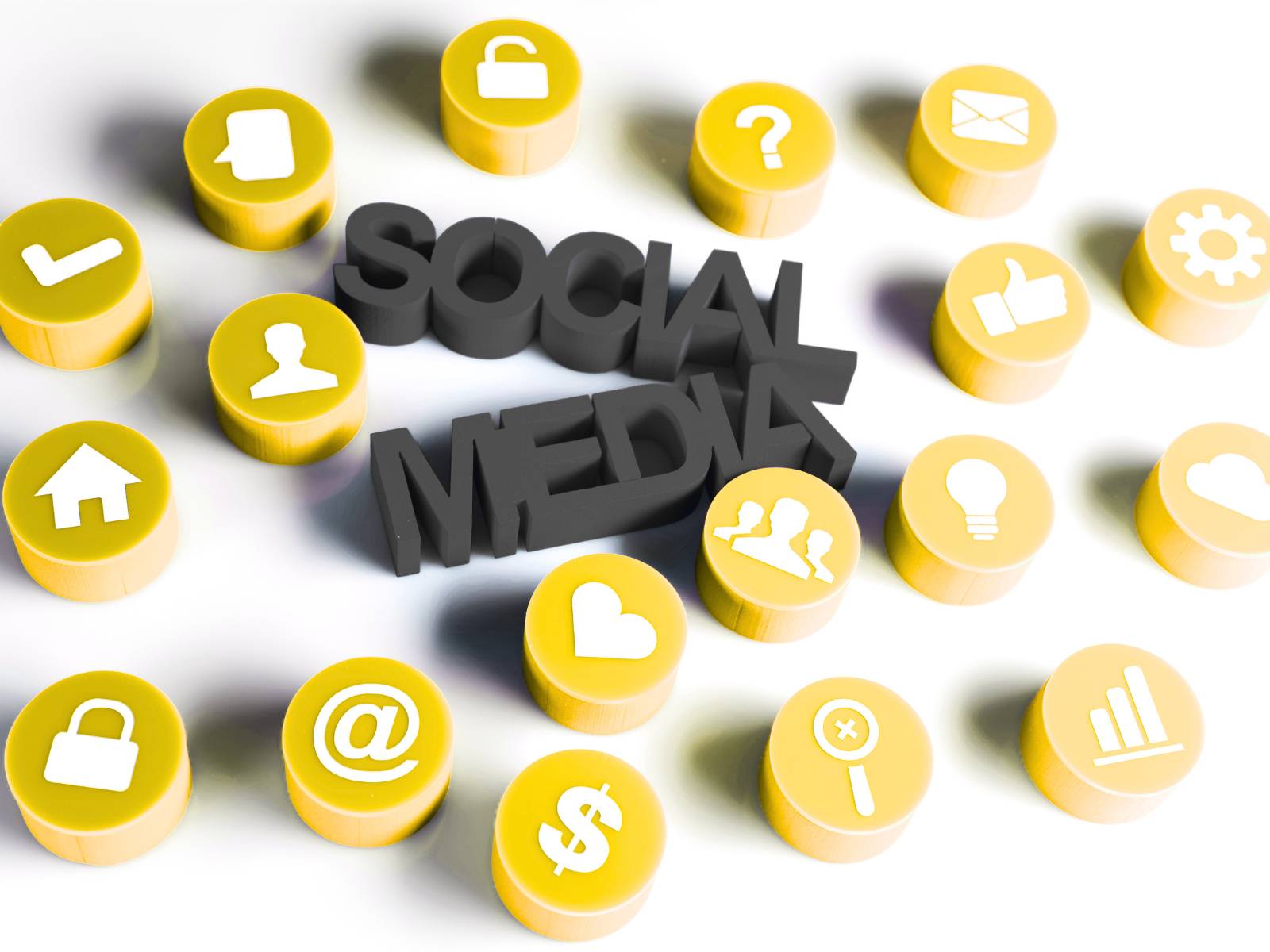 Sociale media: De woorden 'SOCIAL MEDIA' in zwarte 3D-letters, omringd door talrijke gele ronde iconen met diverse witte symbolen zoals een hartje, @-teken en een gebruikersprofiel