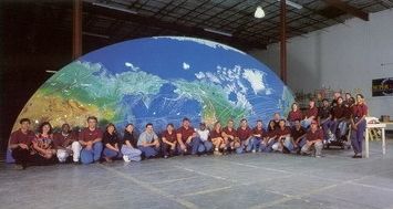 Super Vision employees in front of one half of the world's largest fiber optic display Super Vision employees in front of one half of the world’s largest fiber optic display