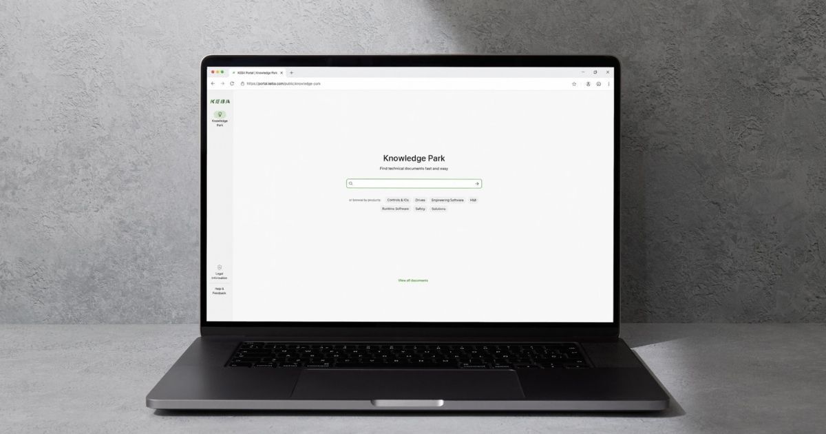 Laptop on a gray surface displaying a search engine page titled "Knowledge Park" with a search bar and navigation options beneath.