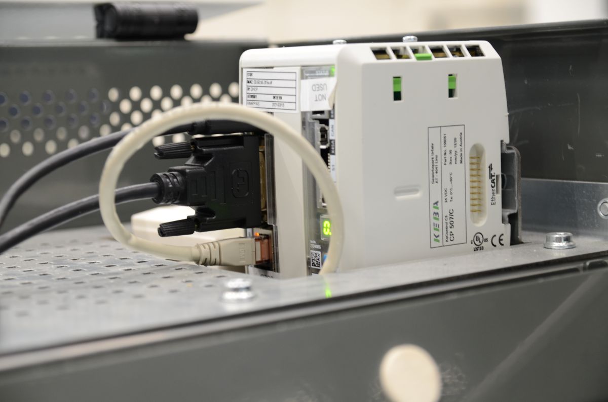 Close-up of a KEBA KeConnect C5 controller with connected cables installed in the Knapp system environment.