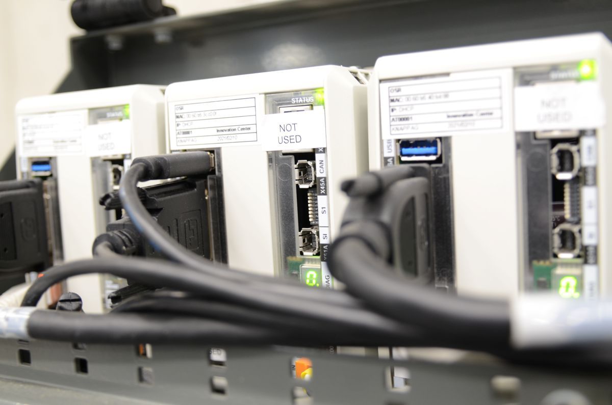 Close-up of industrial control modules with cables connected, labeled "NOT USED," mounted on a metal rack.