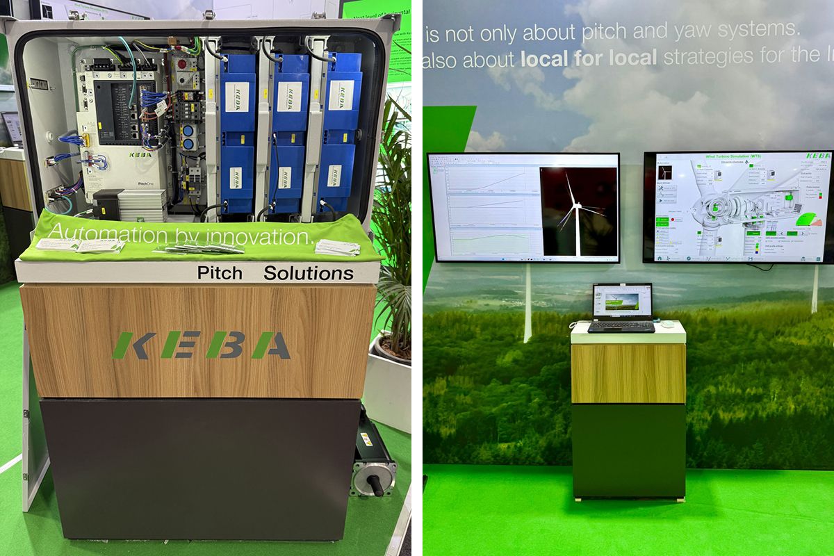 Three KEBA team members smiling and pointing at the trade fair wall "Hall 2"