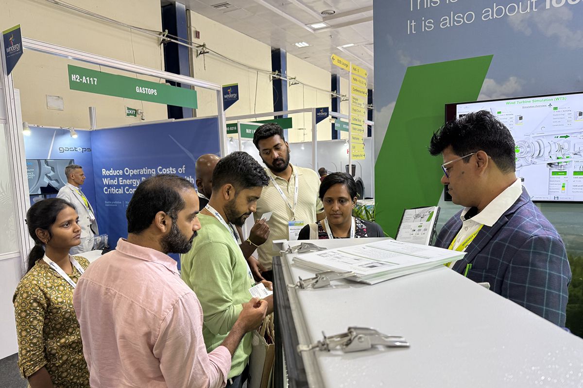 Several trade fair visitors engaged in discussion at KEBA’s Windergy Booth. 