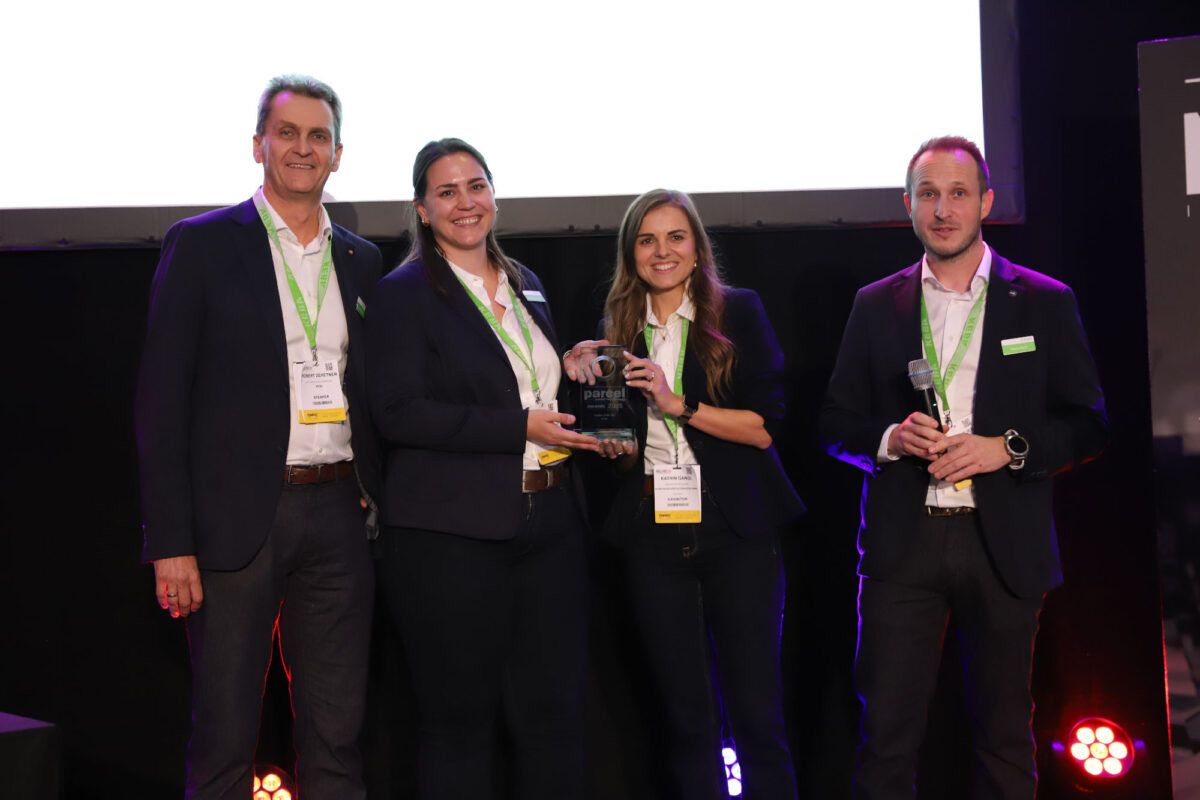 Robert Zehetner, Korinna Aschauer, Katrin Gangl and Patrick Gojer from KEBA stand on stage, smiling and holding the Supplier of the Year award.