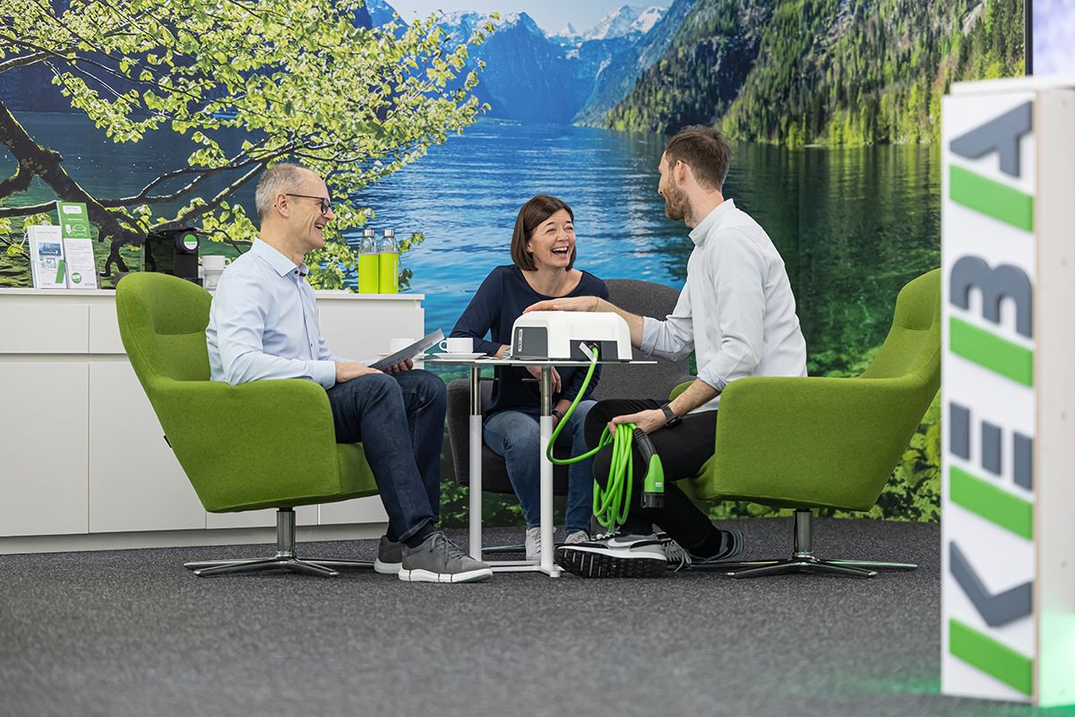 Customer meeting at a table with landscape wall image in the background.