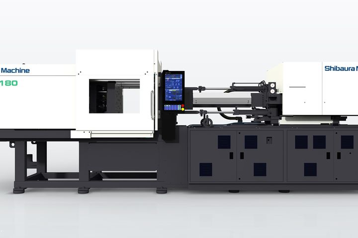 Seitenansicht einer Shibaura Machine S-GenXt180 Spritzgussmaschine mit Bedienfeld und geschlossenem Formbereich.
