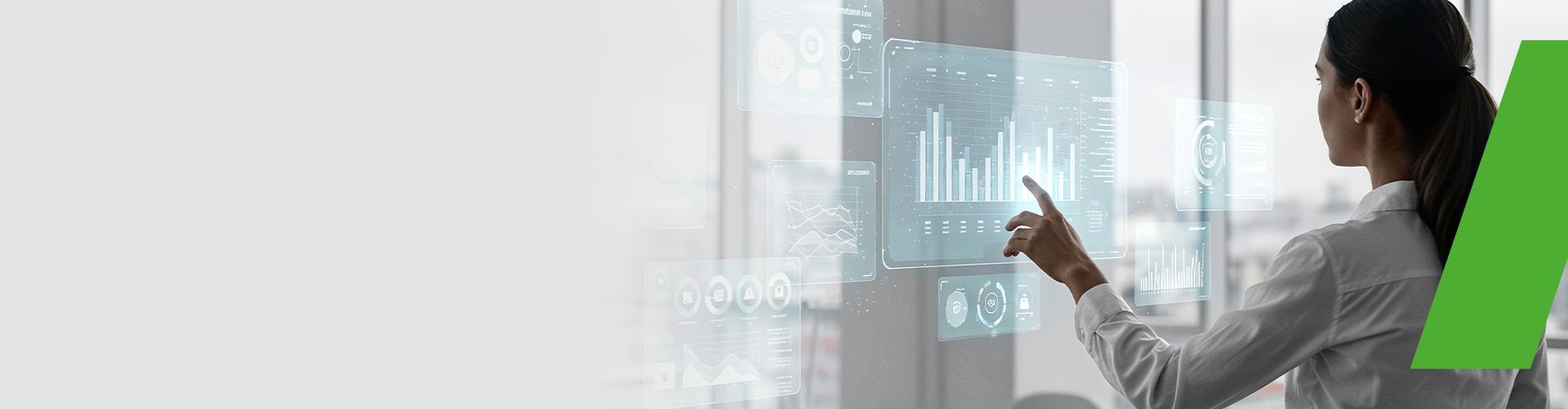 Woman pointing at a transparent touchscreen interface displaying data charts and graphs - representing digital products