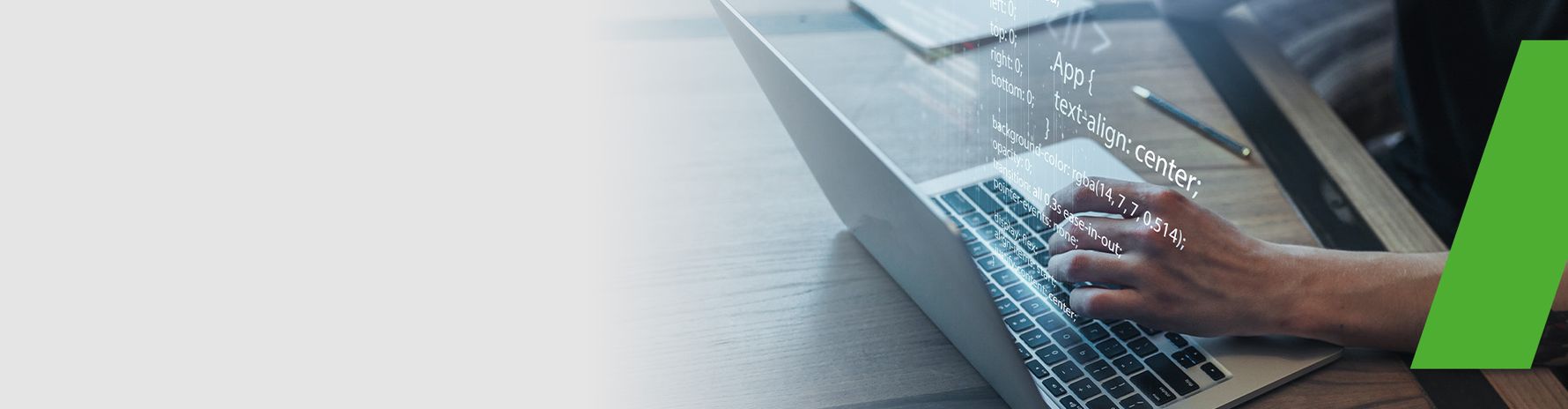 Developer working on a laptop with visible code – a symbol of programming and software development.