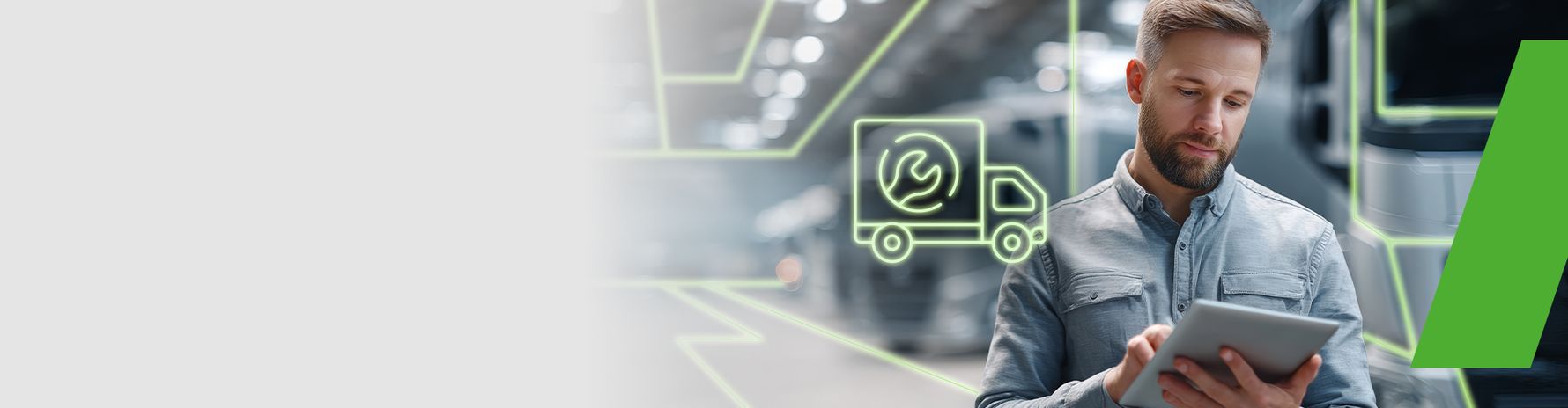 Mann arbeitet mit einem Tablet; Symbol für digitalen Service und Fahrzeugwartung im Hintergrund.