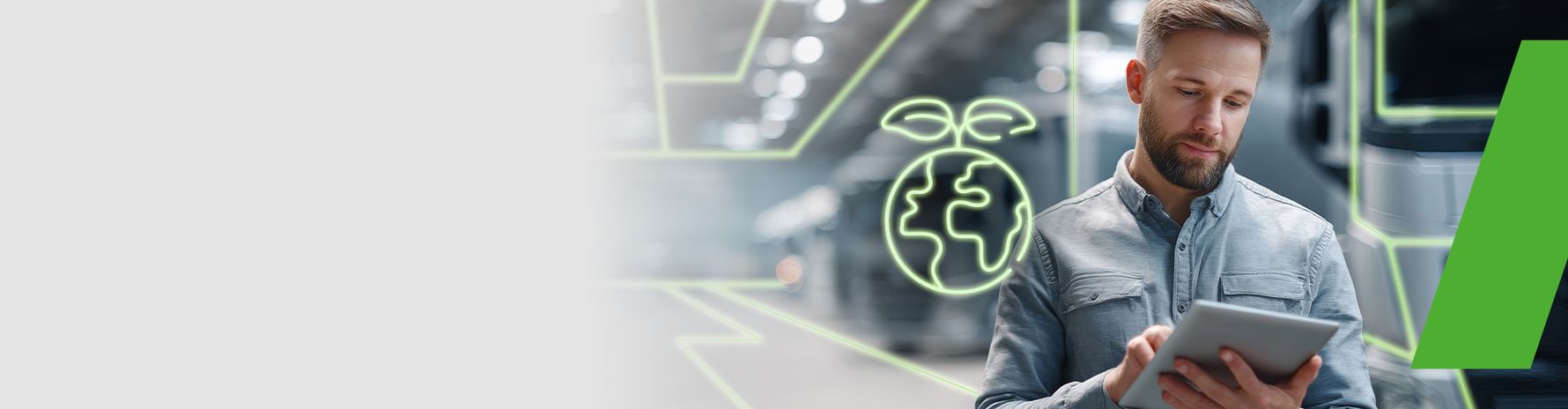 Man using a tablet in a modern industrial setting; symbol of sustainability and environmental awareness in the background.