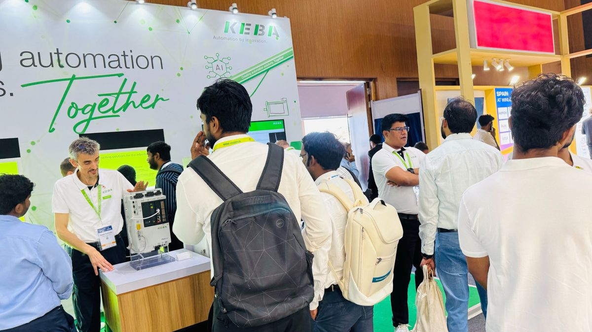Several trade fair visitors engaged in discussion at KEBA’s Windergy Booth. 