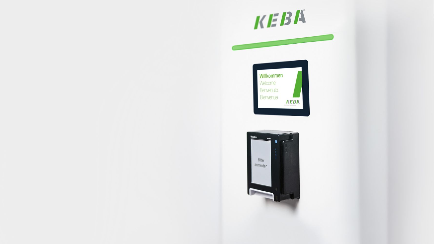 Shown is the KEBA KeContact DCW15 Public Wallbox, mounted on a white wall, with digital display and connected charging cable.