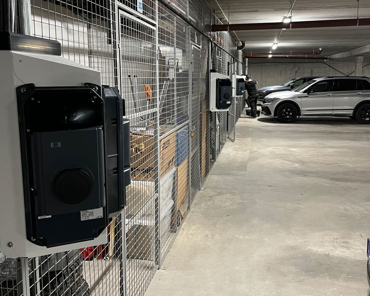 View of multiple KEBA wallboxes installed along a grid wall in an underground garage.