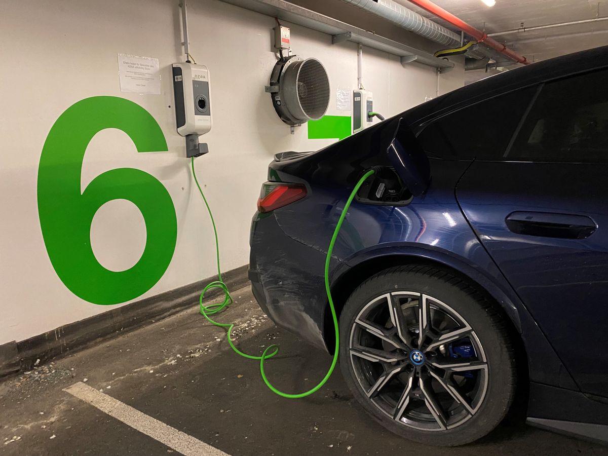 An electric car is being charged at a KEBA wallbox in an underground garage at parking spot number 6.