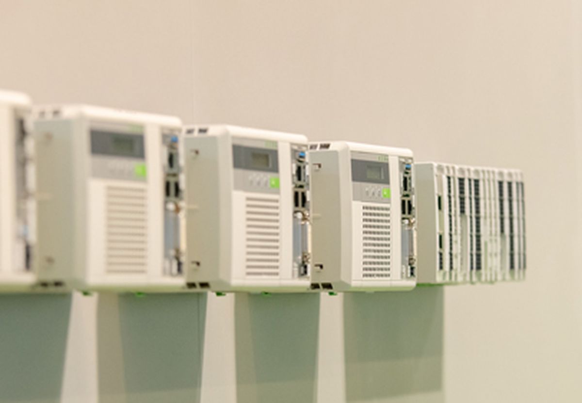 Row of modular industrial control and I/O devices mounted on a wall, illustrating scalable automation systems.