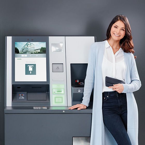 A woman operates an evo ATM.