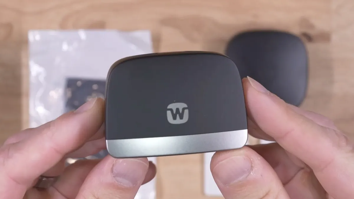 There are two options for recharging the aids: The standard L-shaped Desktop charger shown here and the Charge n Clean charger.