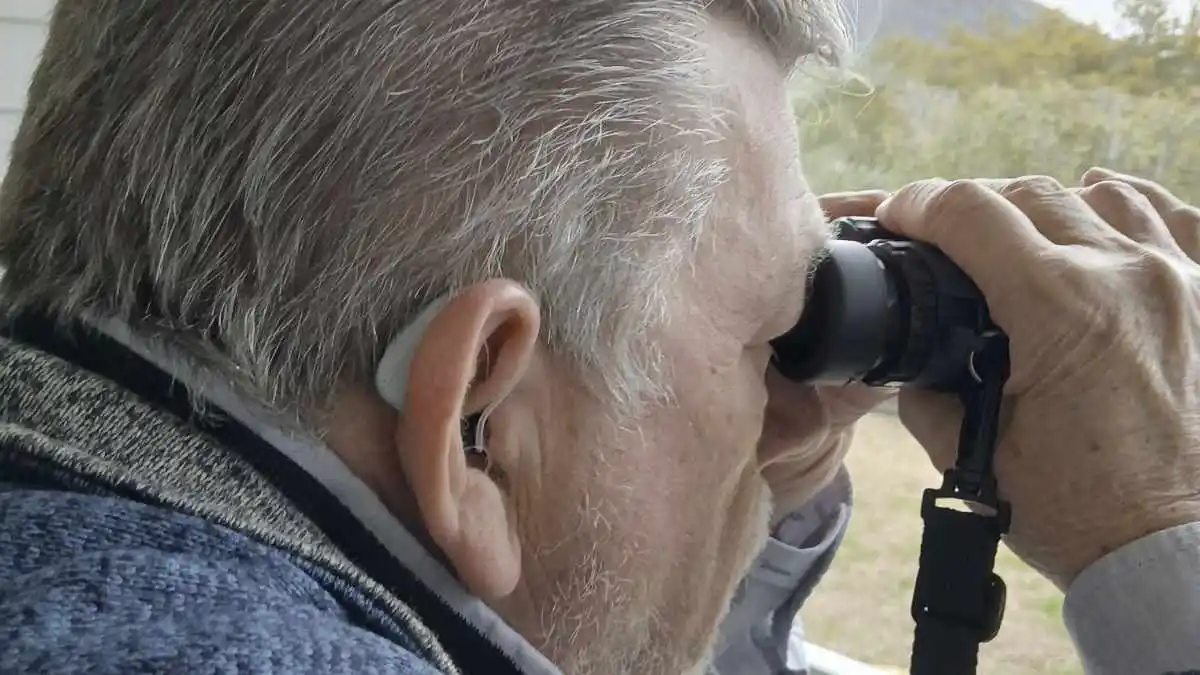 Author and birdwatcher David Cochran with hearing aids and binoculars